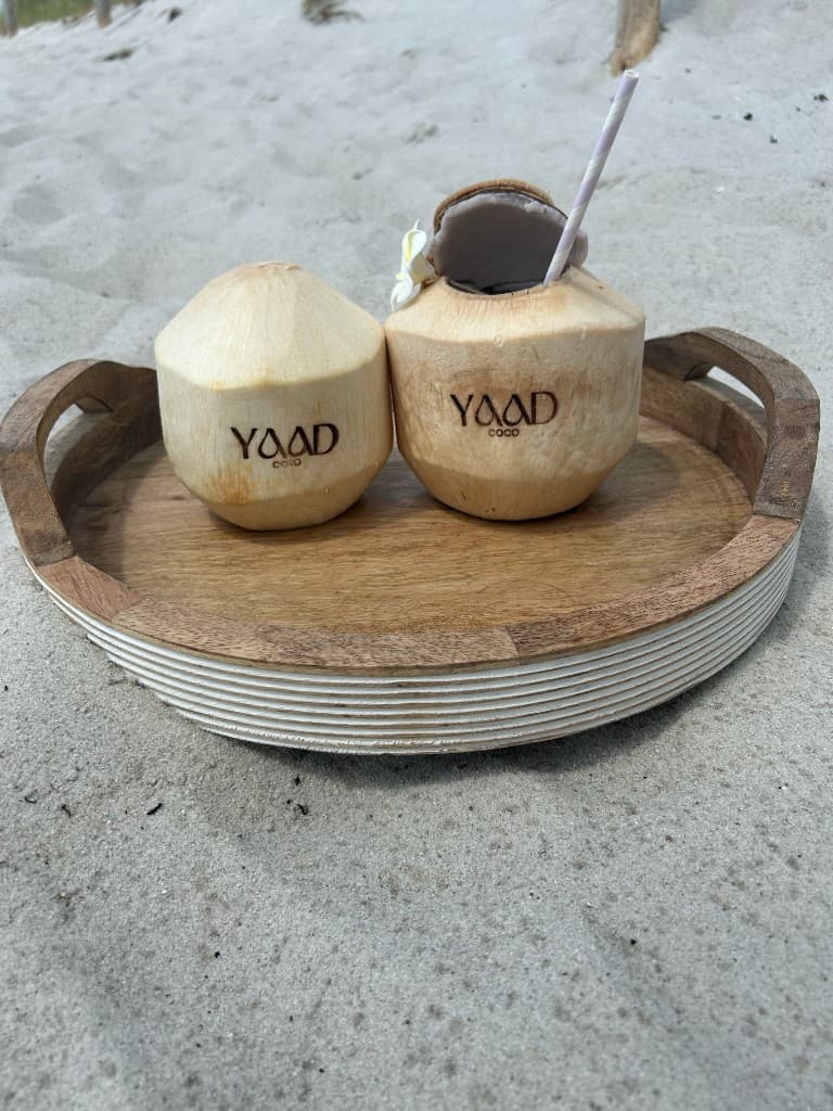 Yaad Coco branded coconuts at a luxury poolside setting